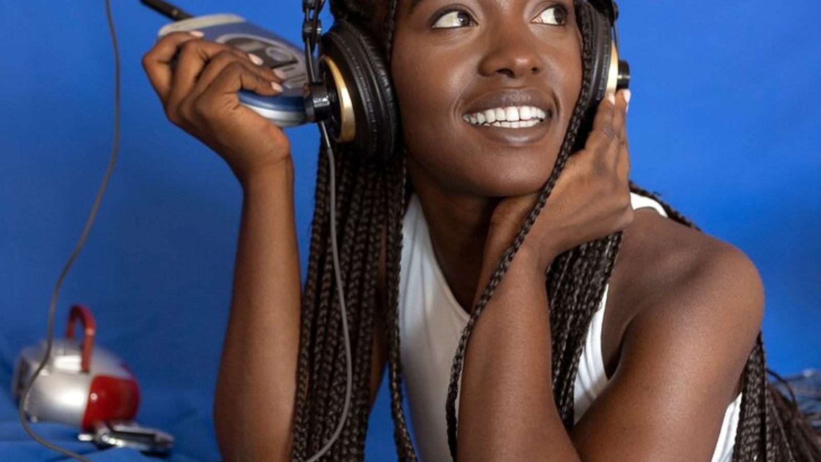 a black lady with headphones listening to music showing the music trends in 2024